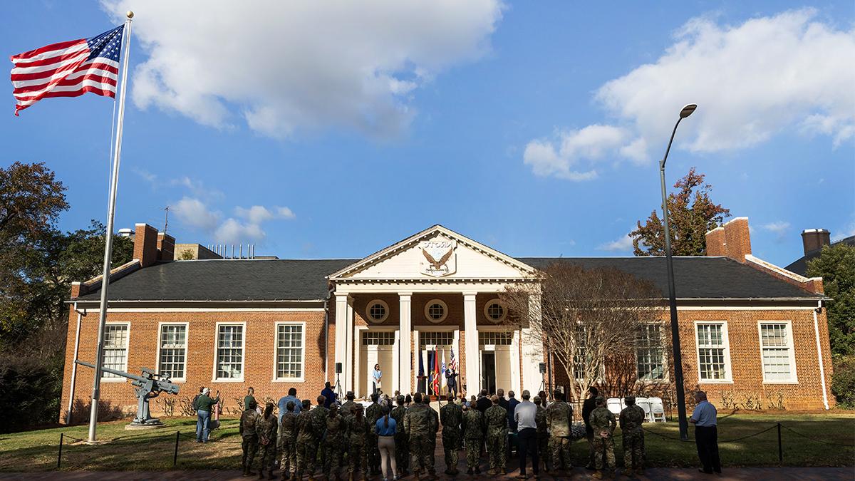 Group of people gathered outside the Naval ROTC Armory on the campus of UNC-Chapel Hill.